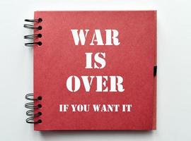 War is over, if you want it. Motivational quote on notebook paper. photo