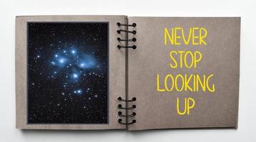 Never stop looking up. Inspirational and motivational quote. Keep optimism concept photo