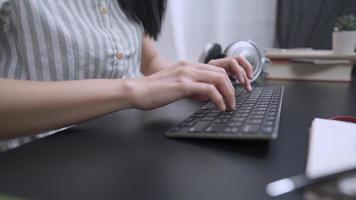 close up female hands typing on wireless keyboard, working at home office working desk, young independent hard worker, modern digital technology gadget, home wireless, writing essay online article video