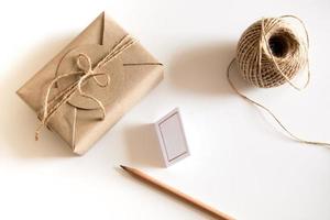 Gift box wrapped in kraft paper and rustic hemp as natural rustic style photo