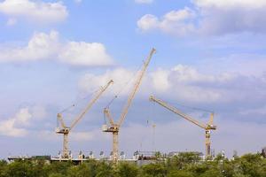 Tower cranes are a modern form of balance crane that used in the construction of tall buildings. photo