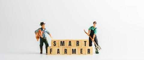 Smart farmer concept. Cube wooden block with the text of smart farmer with a small figure. photo