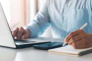 Business man calculating money, money planning, loan budget, online payment concept on computer, working paperwork at home desk. photo