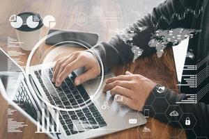 The idea of a digital Interface, dark Dark Screen, a link icon, young financial analyst working at the male office, using contemporary laptops. photo