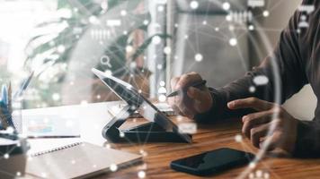 young man's hand with a tablet. A man who works remotely at home has ideas about the network or remotely runs a global business network. photo