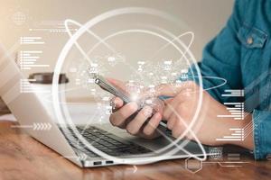 young man's hand with a laptop. A man who works remotely at home, ideas about the network or remotely running a global business network. photo