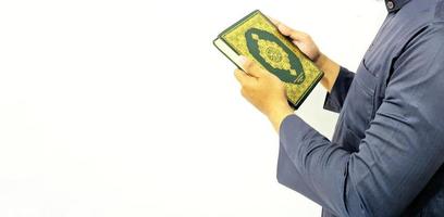 Man Holding and reading quran. Islamic Background photo