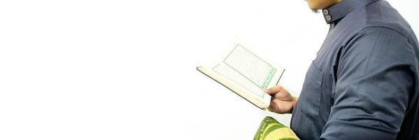 Man Holding and reading quran. Islamic Background photo