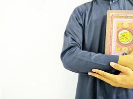 Man Holding and reading quran. Islamic Background photo