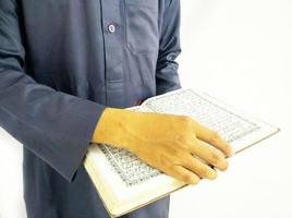 Man Holding and reading quran. Islamic Background photo