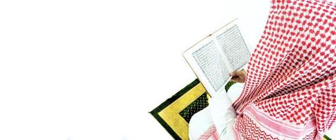 Man Holding and reading quran. Islamic Background photo