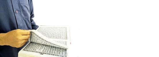 Man Holding and reading quran. Islamic Background photo