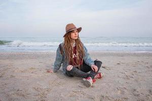 Portrait of young woman walking on the autumn beach photo