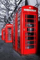 Red phone booths on black and white photo