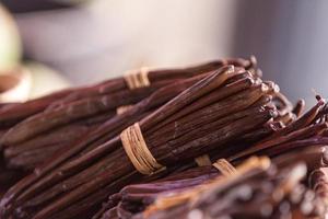 Bundles of vanilla beans on a market stall photo