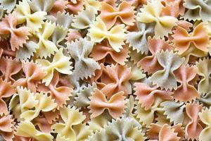 Stack of colorful uncooked farfalle photo