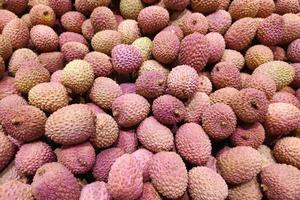 Stack of lychees on a market stall photo