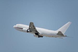 A commercial airplane taking off at an airport. photo