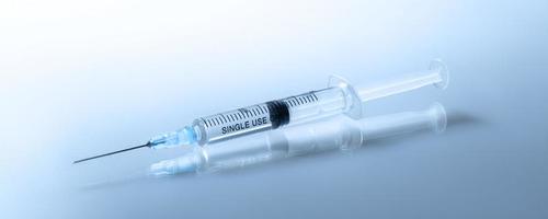 Medical syringe with a needle and vaccine against corona virus. photo