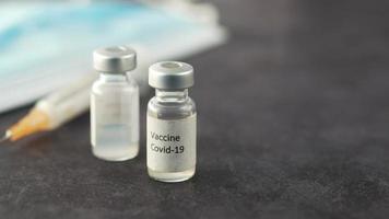 Close up of coronavirus vaccine and syringe video