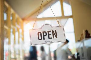 Open sign hanging on door cafe photo