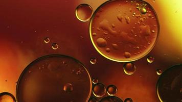 Abstract Colorful Food Oil Drops Bubbles and spheres Flowing on Water Surface, macro Videography video