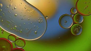 Abstract Colorful Food Oil Drops Bubbles and spheres Flowing on Water Surface, macro Videography video