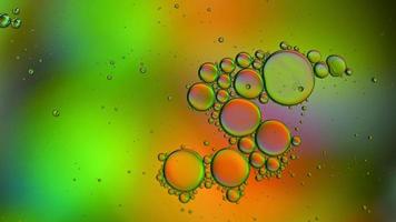 Abstract Colorful Food Oil Drops Bubbles and spheres Flowing on Water Surface, macro Videography video