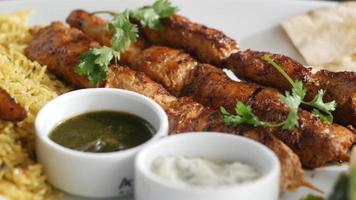Seekh Kabab, bread, and sauce on a plate . video