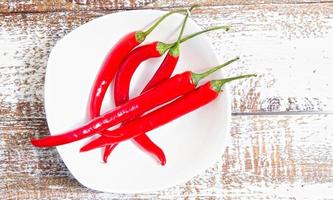 red hot chili pepper corns vintage metal culinary background - top view photo