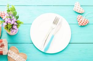 Valentines day set with silverware. Valentine day love beautiful. Romantic dinner, tableware and hearts on wooden background.Top view. photo