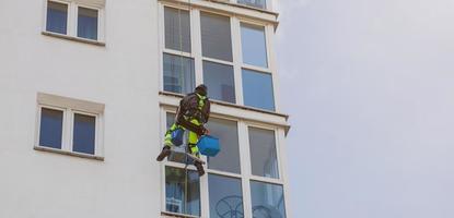 Minsk, Belarus, May 2022 - Person cleaning building window photo