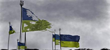 Ragged Ukrainian blue and yellow flag on sad grey sky background photo