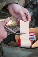 Military army first aid kit. Camouflaged soldier medic. photo