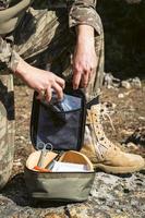 Military army first aid kit. Camouflaged soldier medic. photo