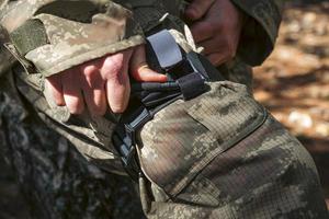 Army soldiers practicing military tourniquet application. photo