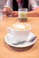 Hot coffee latte on a wooden table. photo