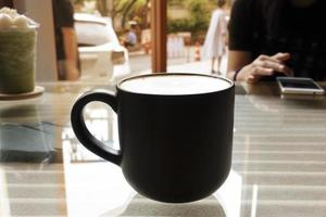 Hot coffee in glass on glass table with inner pattern. photo