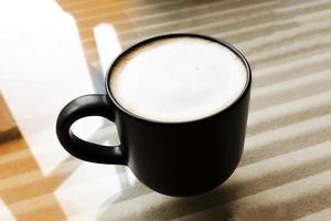 Hot coffee in glass on glass table with inner pattern. photo