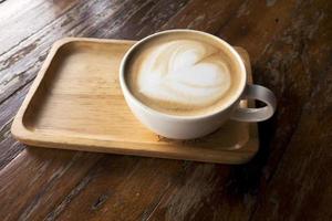 Hot latte on a wooden table photo