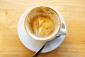 The art of hot coffee on a wooden table. photo