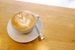 The art of hot coffee on a wooden table. photo