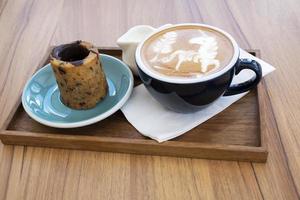 Hot latte with cookies on a wooden table photo