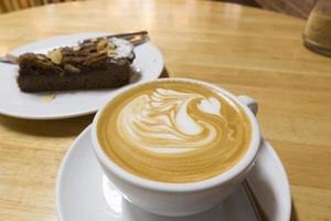 Hot coffee on wooden table photo