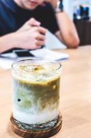 ice matcha latte on a wooden table. photo