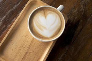 Hot latte on a wooden table photo