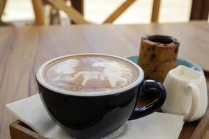 Hot latte with cookies on a wooden table photo