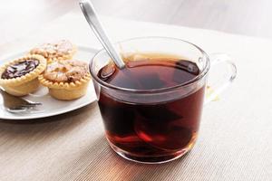 Tea time with hot tea and dessert tarts photo