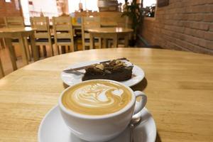 Hot coffee on wooden table photo