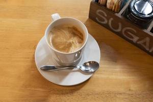 Hot coffee on wooden table photo